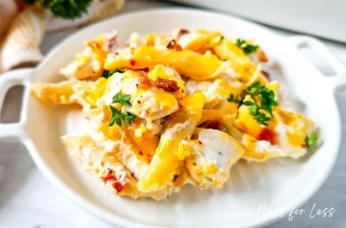 creamy crack chicken with melted cheddar and bacon served in a white dish