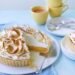 toasted meringue topped lemon pie with a slice served on a plate