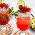 two Shirley Temple mocktails with ice, grenadine, cherry skewers and lime slices