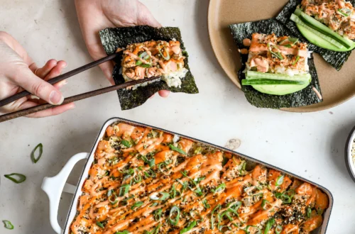 sushi bake casserole with spicy mayo drizzle served with nori sheets, cucumber and green onion